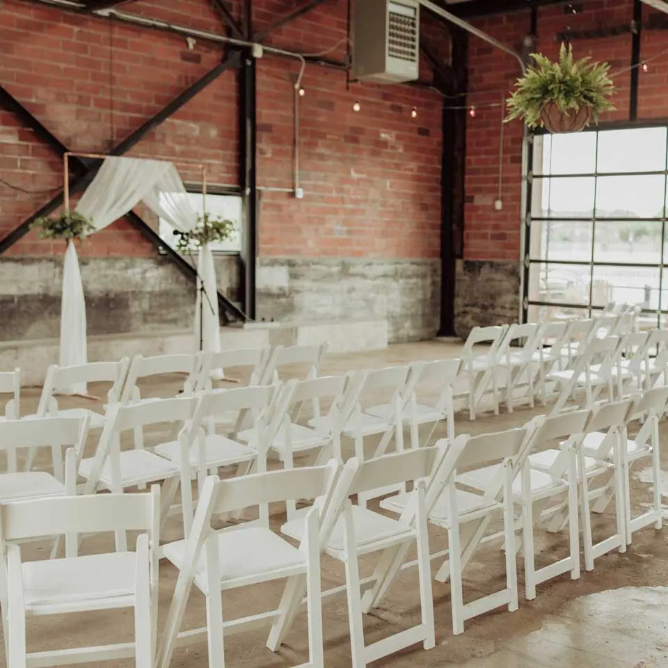 White chairs and wedding altar setup inside City House