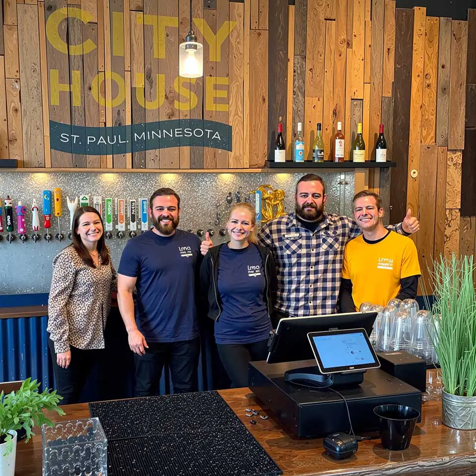 City House staff smiling while standing behind counter